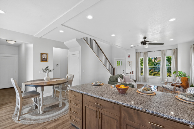 681 Island Road Morgan, UT 84050 - Photo 10 of 49 Kitchen island featuring a granite-style countertop and wood-finish cabinetry with brass hardware