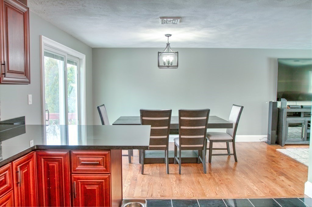 143 North Road Chelmsford, MA 01824 - Photo 12 of 42 a view of a dining room with furniture and wooden floor