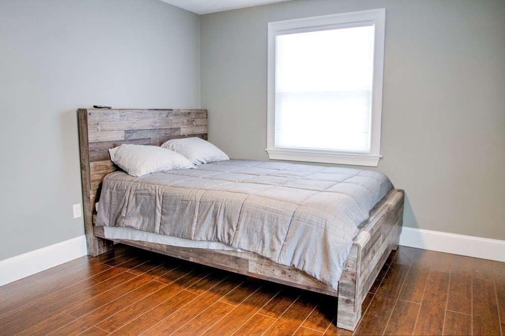 143 North Road Chelmsford, MA 01824 - Photo 17 of 42 a bedroom with a bed and wooden floor