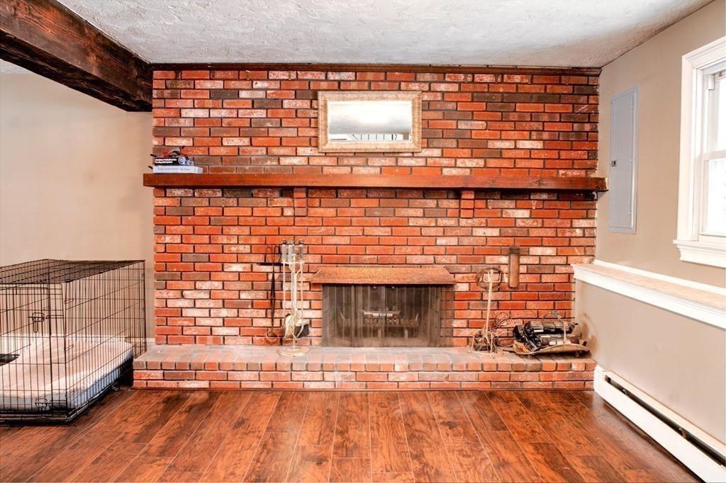 143 North Road Chelmsford, MA 01824 - Photo 26 of 42 a view of empty room with wooden floor and fireplace