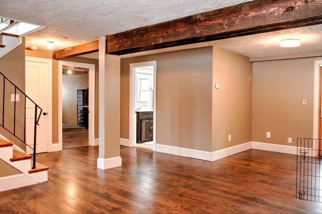 143 North Road Chelmsford, MA 01824 - Photo 29 of 42 a view of an empty room with wooden floor and entrance
