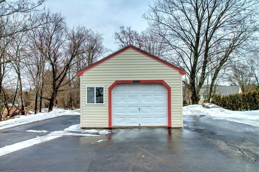 143 North Road Chelmsford, MA 01824 - Photo 35 of 42 a front view of a house with a yard and garage