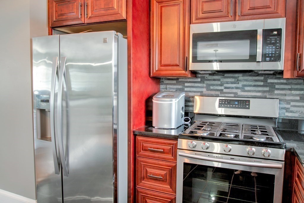 143 North Road Chelmsford, MA 01824 - Photo 5 of 42 a kitchen with stainless steel appliances granite countertop a stove and a refrigerator