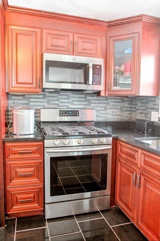 143 North Road Chelmsford, MA 01824 - Photo 6 of 42 a kitchen with granite countertop a stove and a sink