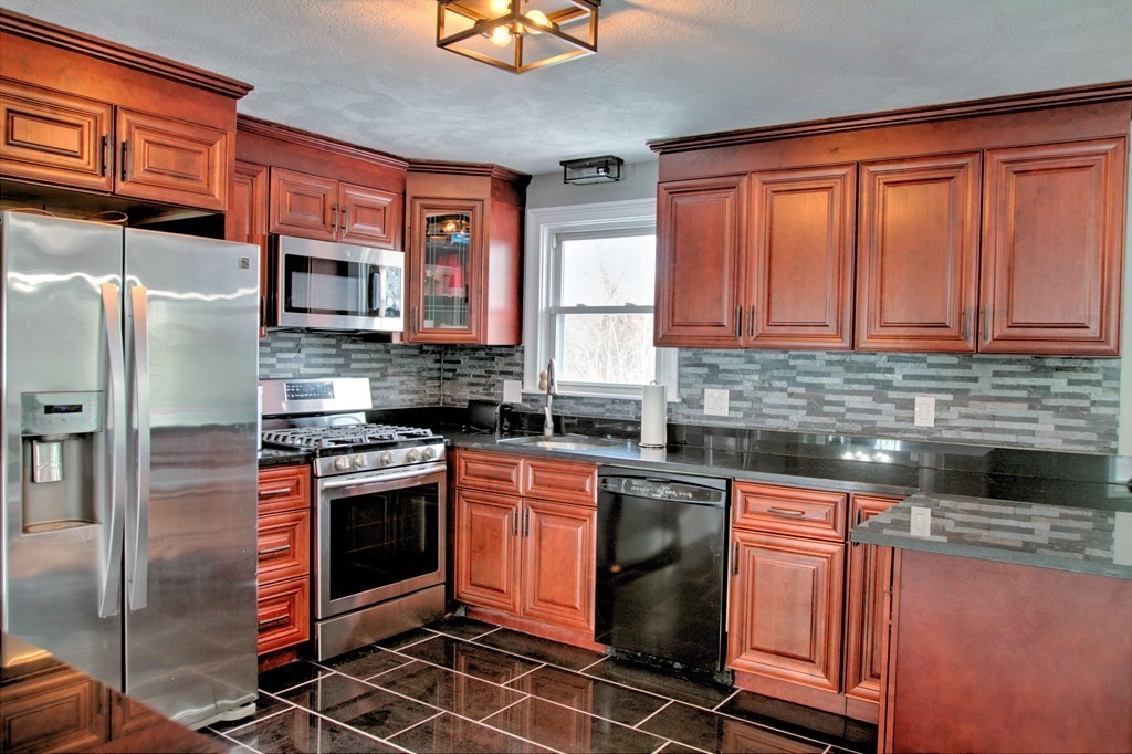 143 North Road Chelmsford, MA 01824 - Photo 7 of 42 a kitchen with stainless steel appliances granite countertop a stove top oven a sink and dishwasher