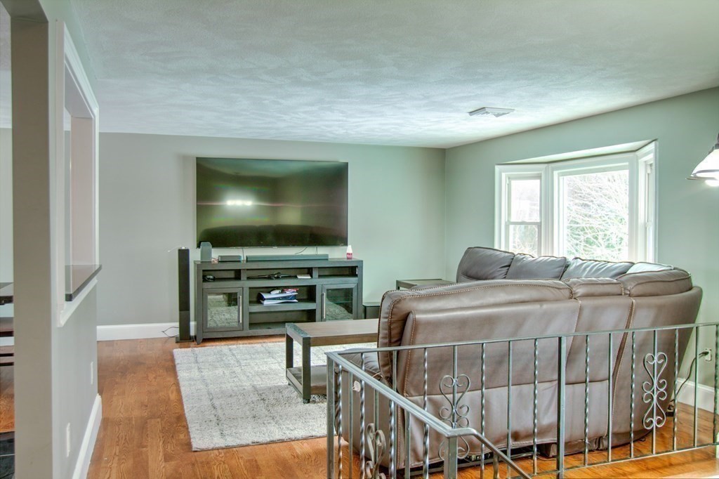 143 North Road Chelmsford, MA 01824 - Photo 10 of 42 a living room with furniture and a flat screen tv