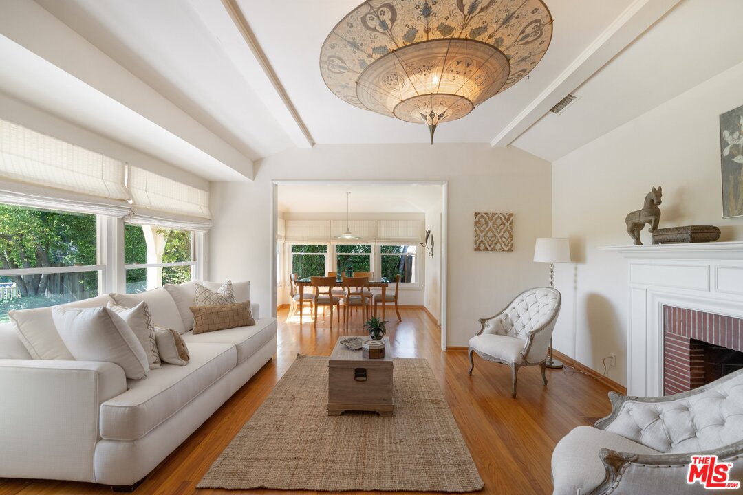 3710 Eureka Drive Studio City, CA 91604 - Photo 13 of 51 a living room with furniture a fireplace and large windows