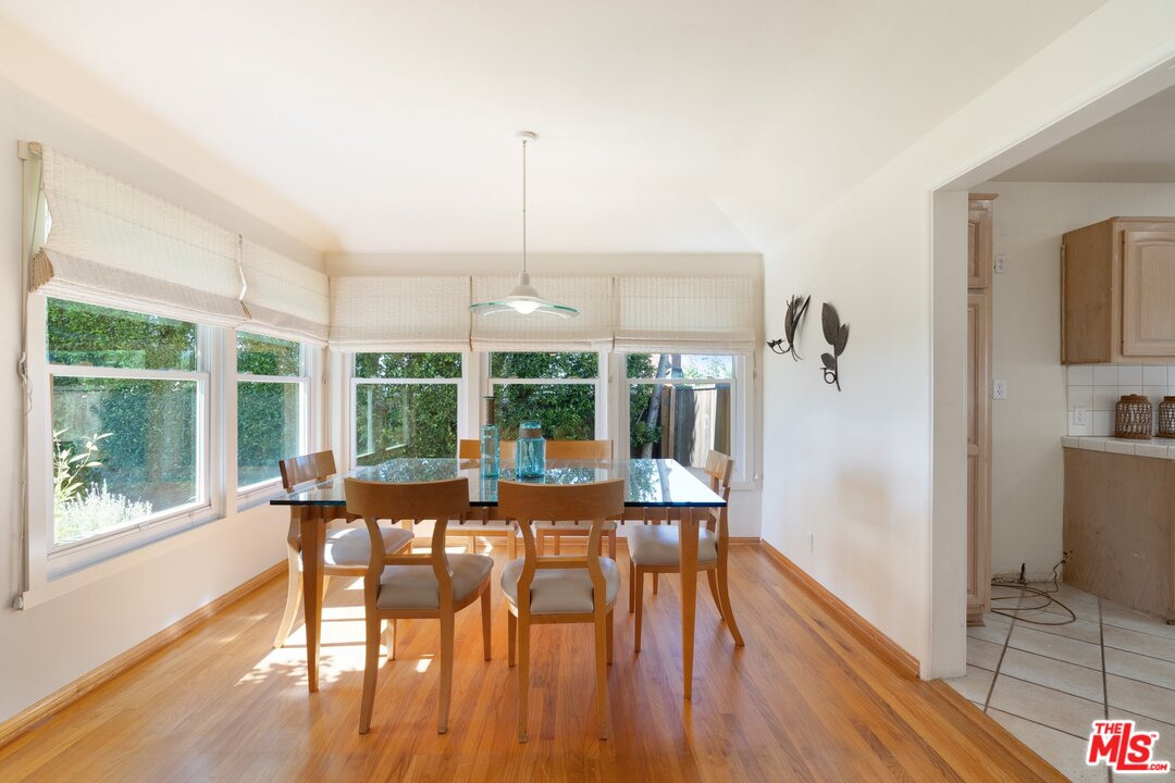 3710 Eureka Drive Studio City, CA 91604 - Photo 15 of 51 a view of a dining room with furniture large windows and wooden floor