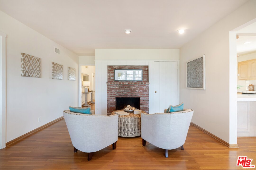 3710 Eureka Drive Studio City, CA 91604 - Photo 27 of 51 a living room with couches a fireplace and a potted plant