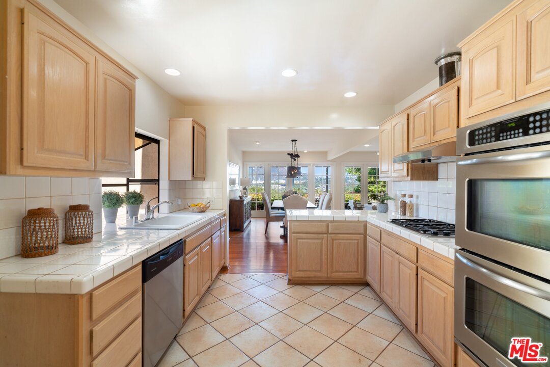 3710 Eureka Drive Studio City, CA 91604 - Photo 30 of 51 a kitchen with stainless steel appliances granite countertop a sink and cabinets