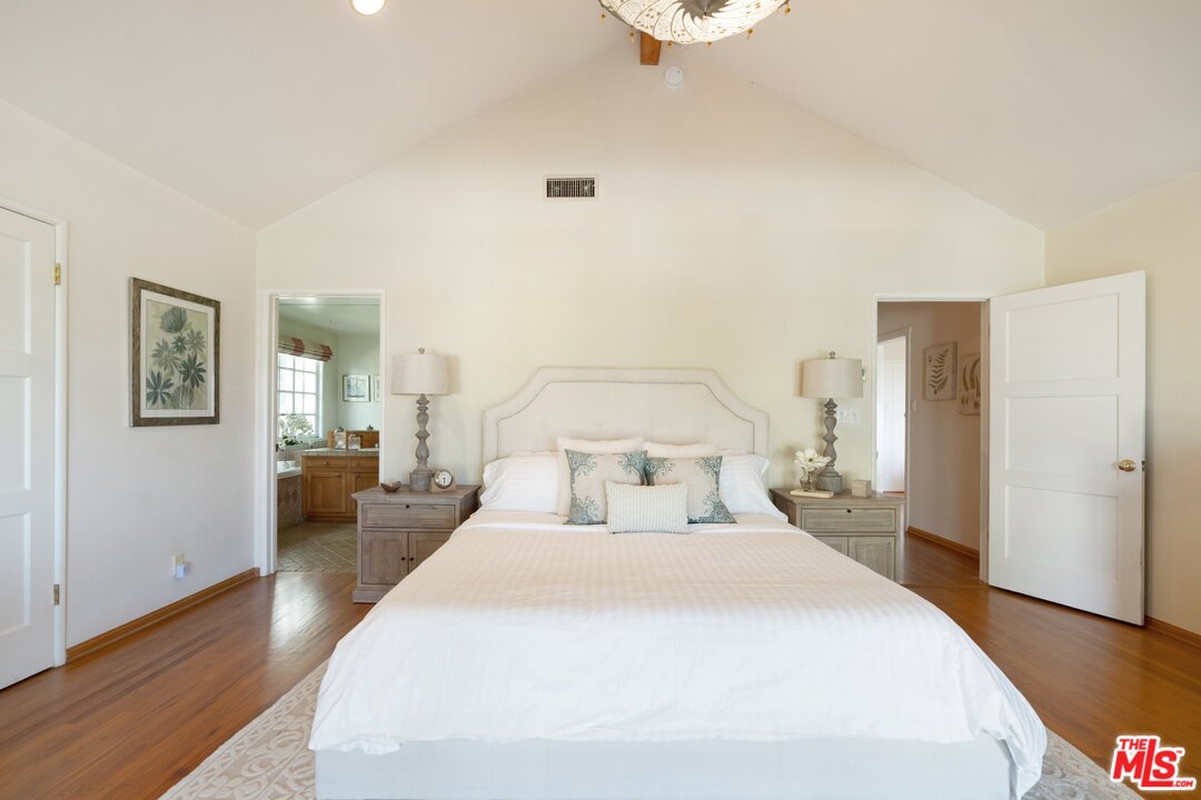 3710 Eureka Drive Studio City, CA 91604 - Photo 39 of 51 a bedroom with a bed and wooden floor