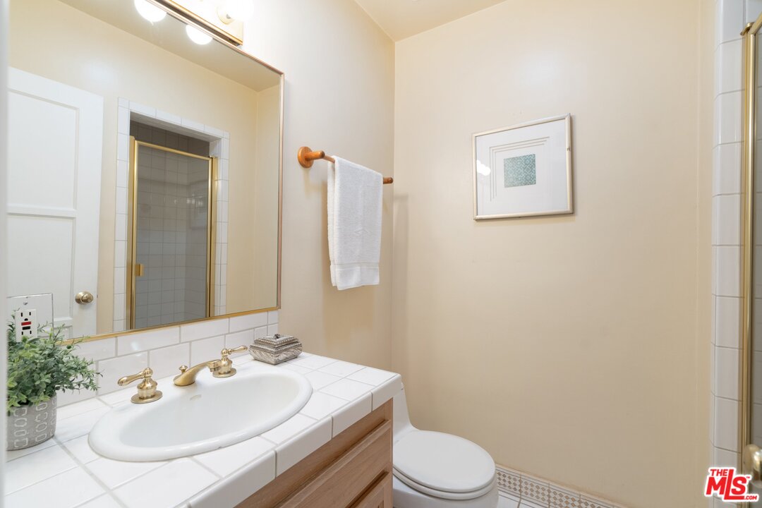 3710 Eureka Drive Studio City, CA 91604 - Photo 46 of 51 a bathroom with a sink a toilet and mirror