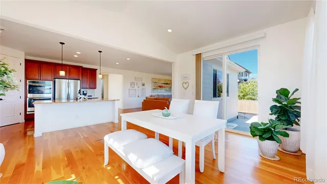 a living room with furniture and a kitchen view