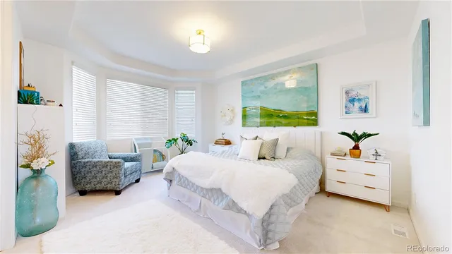 a bedroom with a bed and a couch