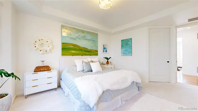 a bedroom with a bed and a painting on the wall