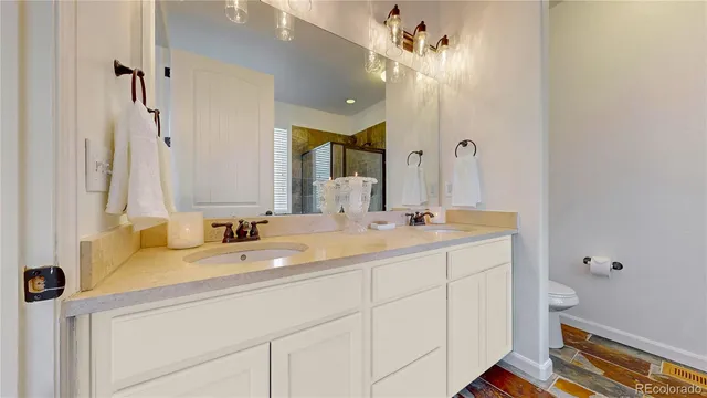 a bathroom with a double vanity sink mirror and