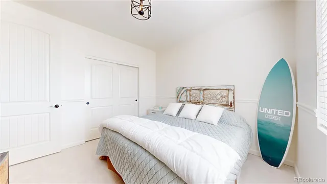 a bedroom with a bed and a mirror