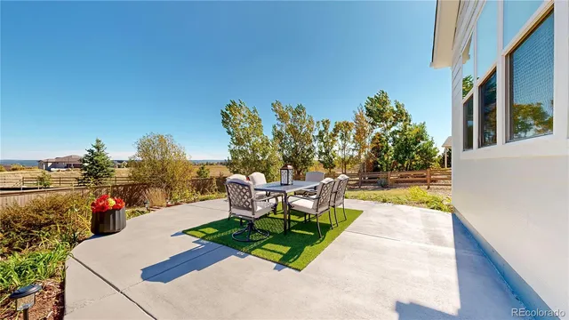 a patio with table and chairs
