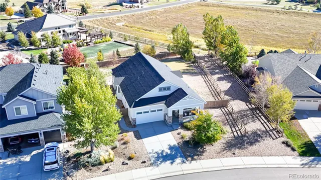 a aerial view of a house with a yard and sitting area