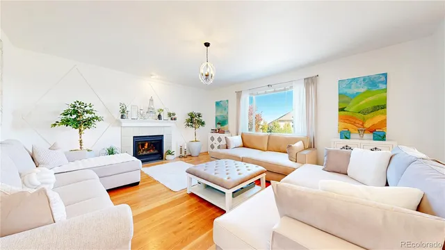 a living room with furniture fireplace and a table