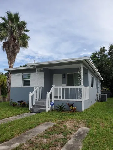 a view of a house with a yard and a garden