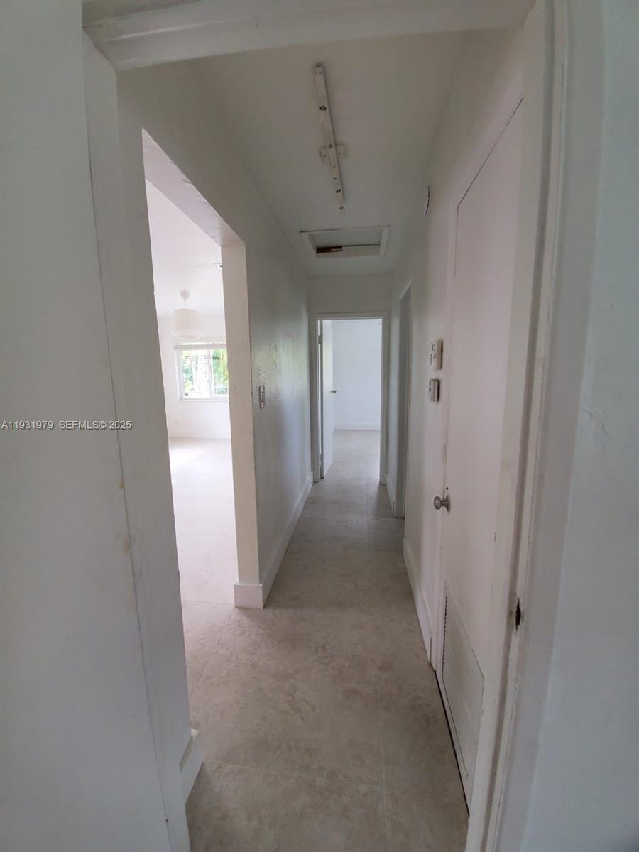 1448 Northeast 152nd Street North Miami Beach, FL 33162 - Photo 9 of 11 a view of hallway with chandelier