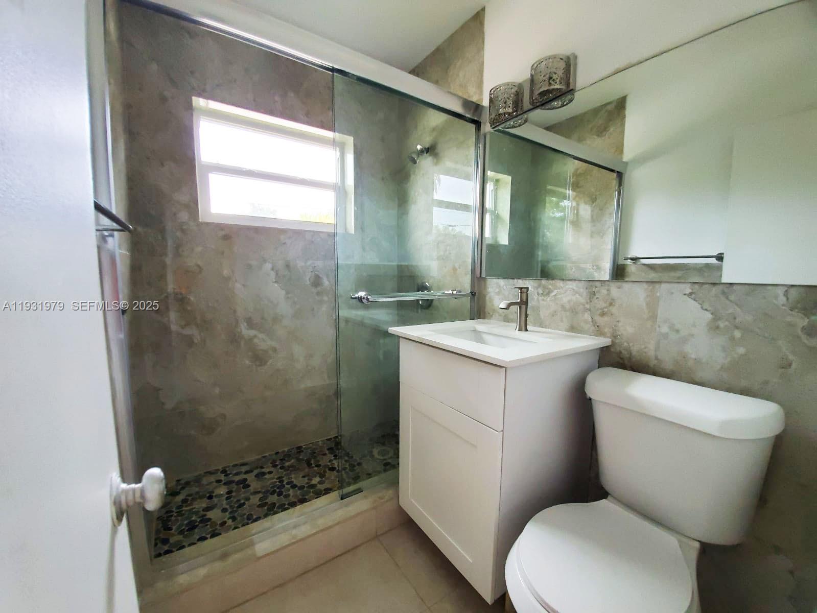 1448 Northeast 152nd Street North Miami Beach, FL 33162 - Photo 10 of 11 a bathroom with a sink toilet and shower