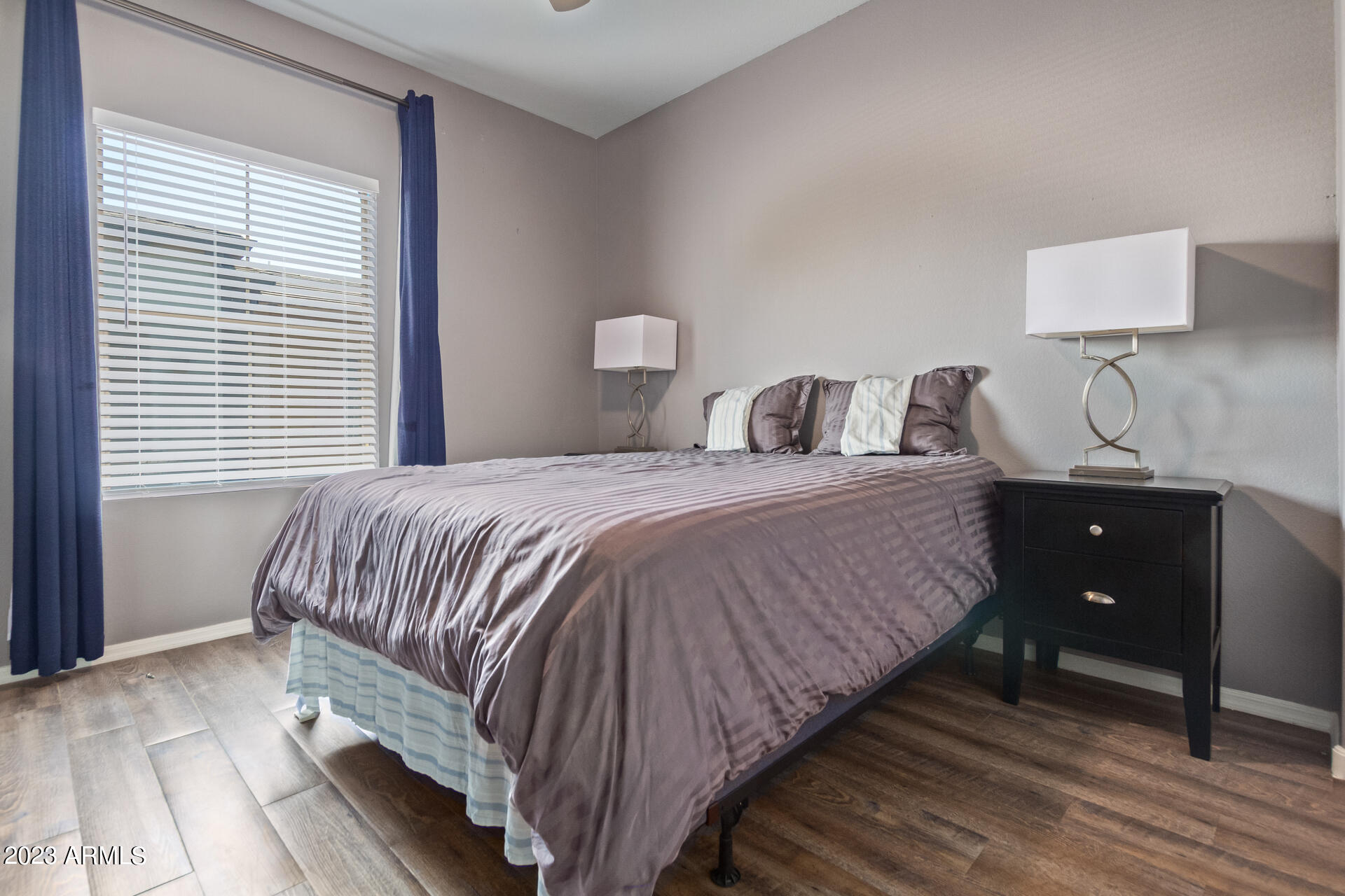 2150 West Alameda Road, Unit 1381 Phoenix, AZ 85085 - Photo 13 of 23 a bedroom with a bed and a lamp on dresser