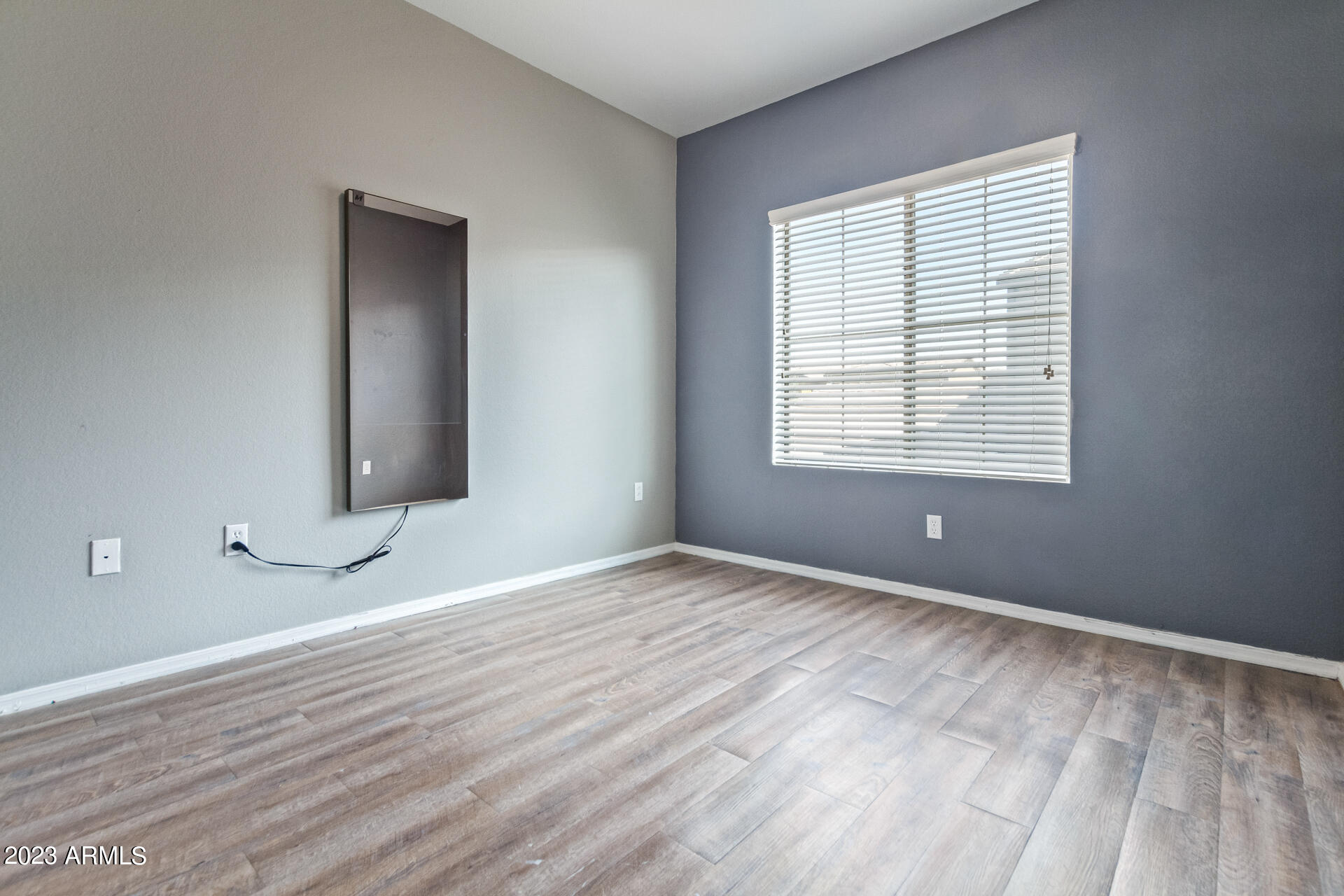 2150 West Alameda Road, Unit 1381 Phoenix, AZ 85085 - Photo 16 of 23 a view of an empty room with window and wooden floor