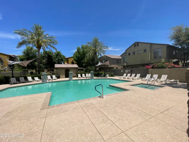 a view of swimming pool with a lounge chairs