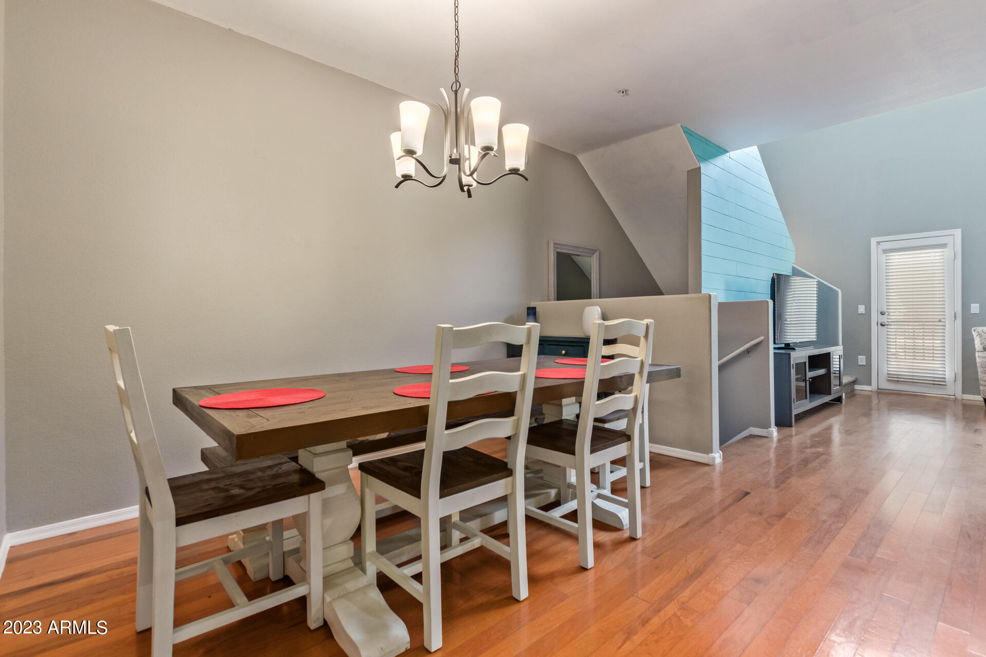 2150 West Alameda Road, Unit 1381 Phoenix, AZ 85085 - Photo 4 of 23 a room with a dining table and wooden floor