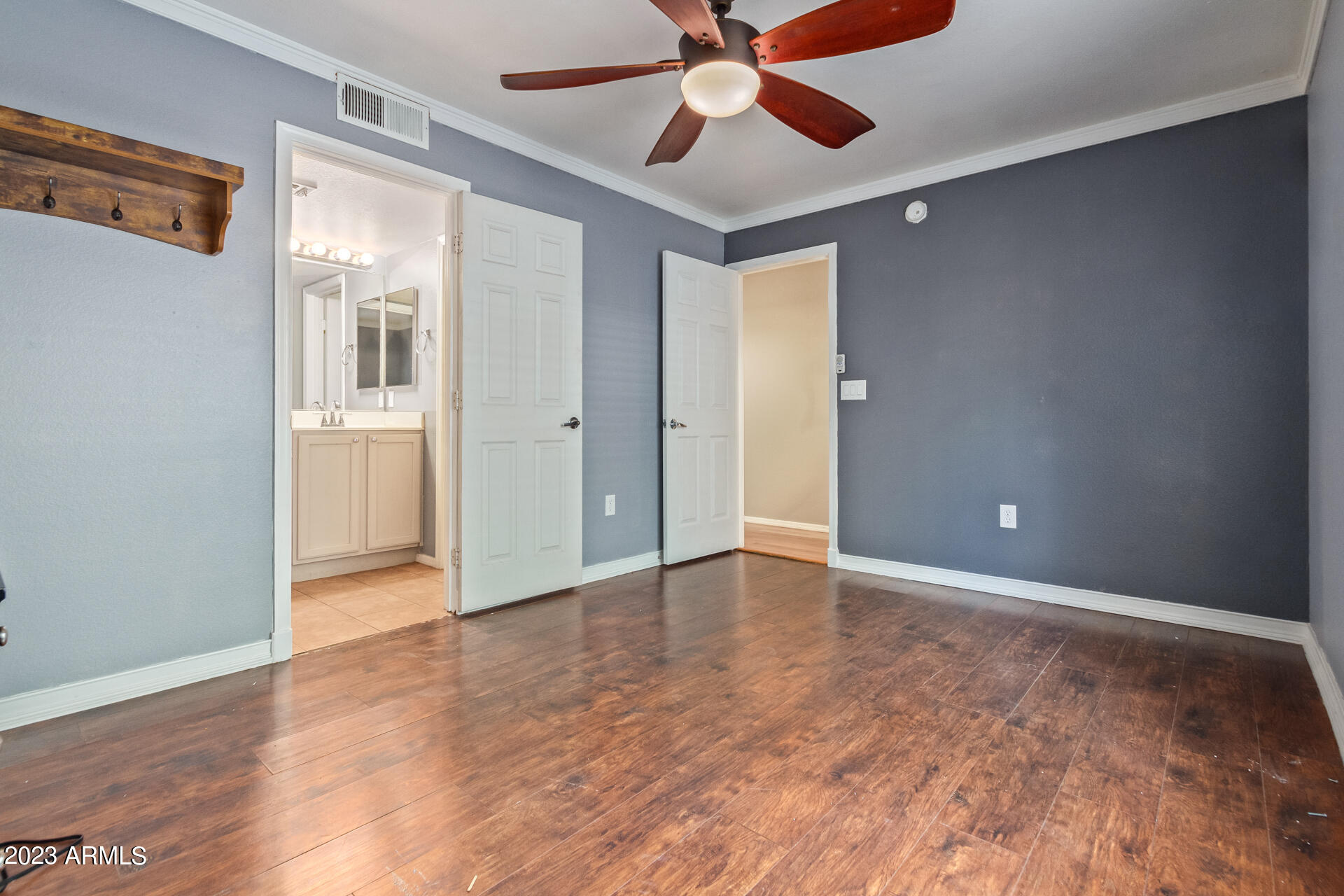 2150 West Alameda Road, Unit 1381 Phoenix, AZ 85085 - Photo 10 of 23 a view of an empty room with wooden floor and a window