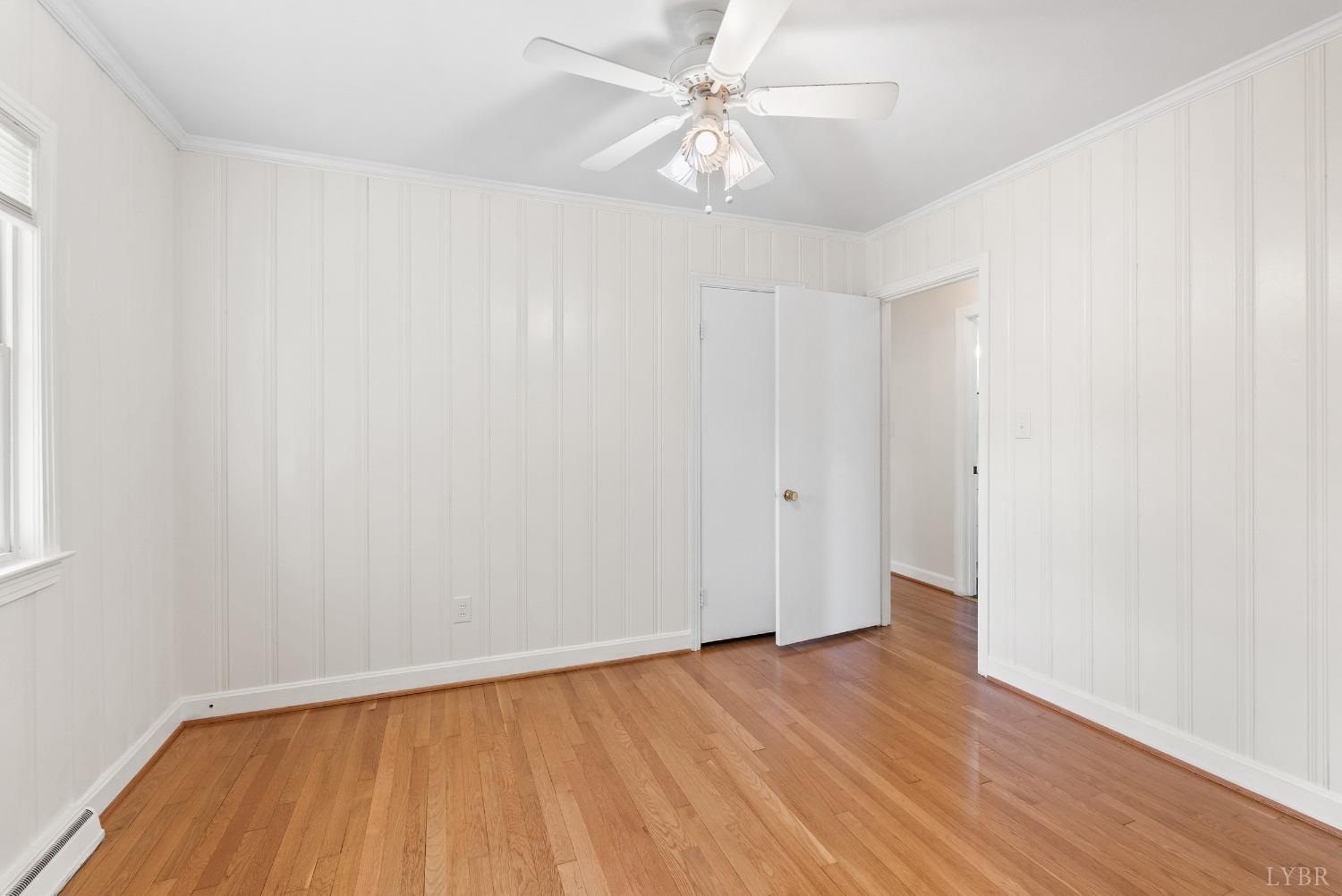 207 Ramsey Road Hurt, VA 24563 - Photo 13 of 32 an empty room with wooden floor and fan