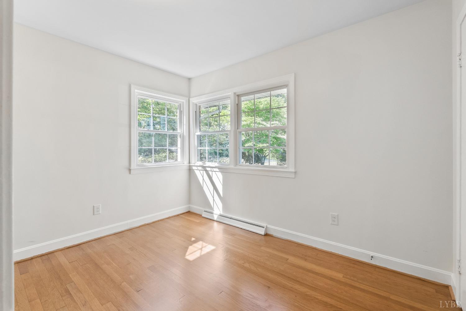 207 Ramsey Road Hurt, VA 24563 - Photo 18 of 32 an empty room with wooden floor and windows