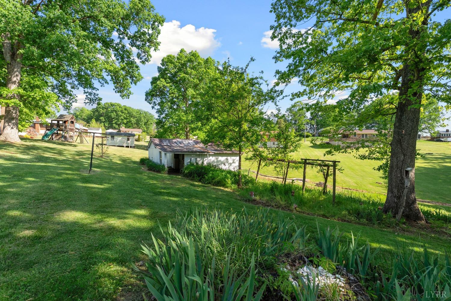 207 Ramsey Road Hurt, VA 24563 - Photo 27 of 32 a backyard of a house with lots of green space and fountain