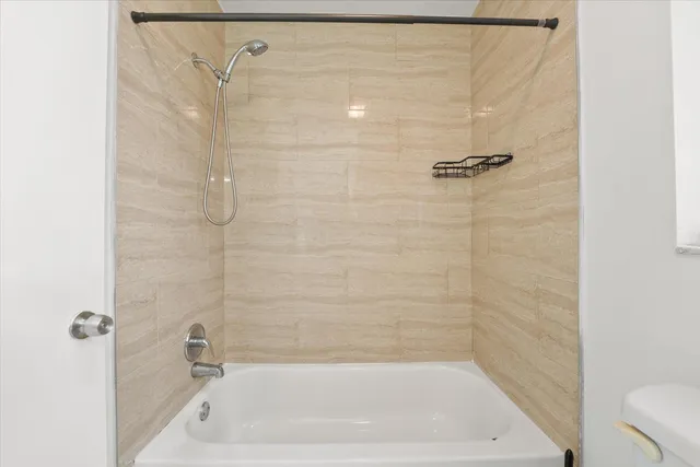 a bathroom with a shower and a toilet