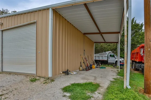 a backyard of a house with barbeque oven table and chairs