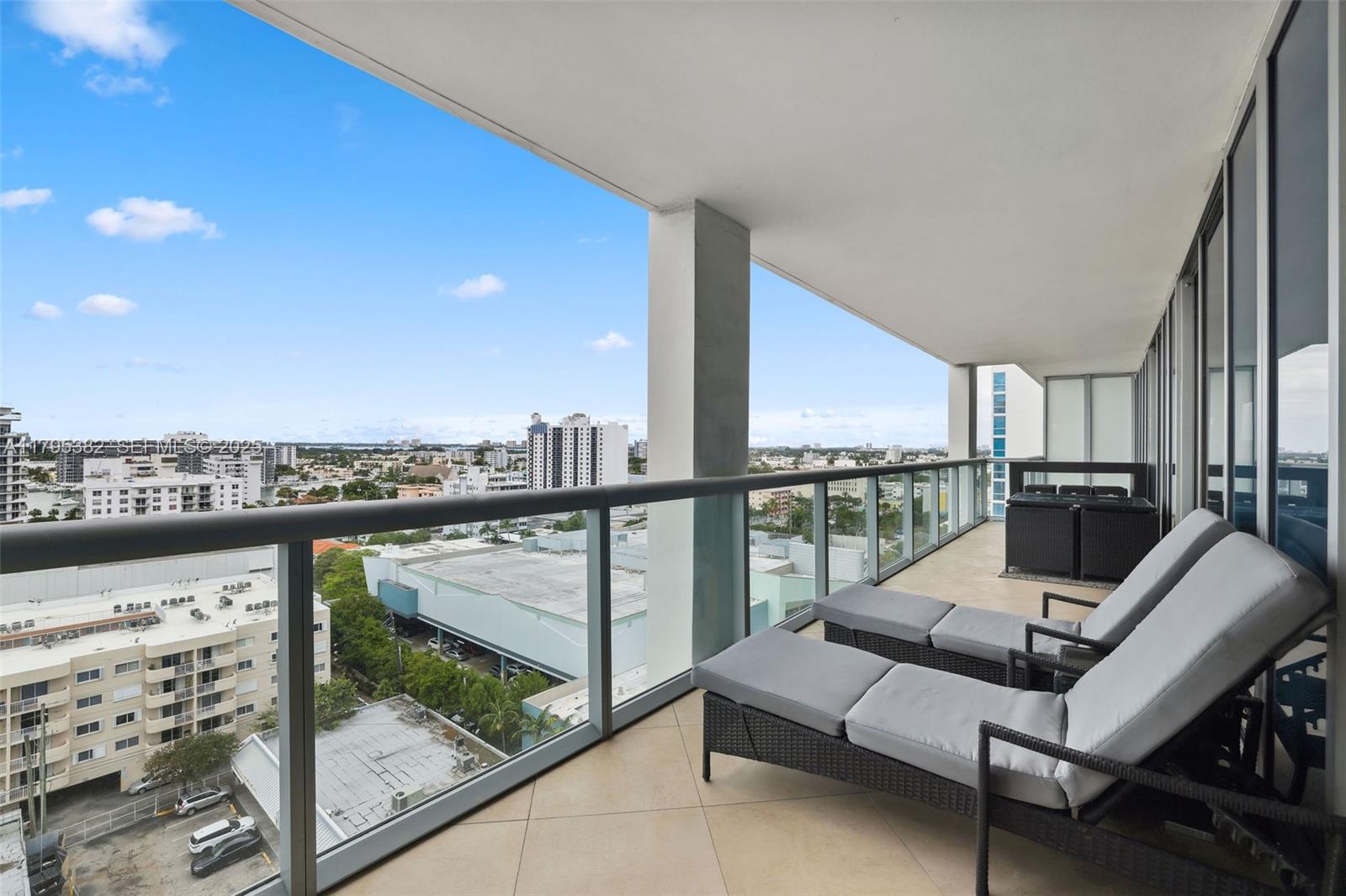 6799 Collins Avenue, Unit 1106 Miami Beach, FL 33141 - Photo 11 of 43 a view of a balcony with furniture