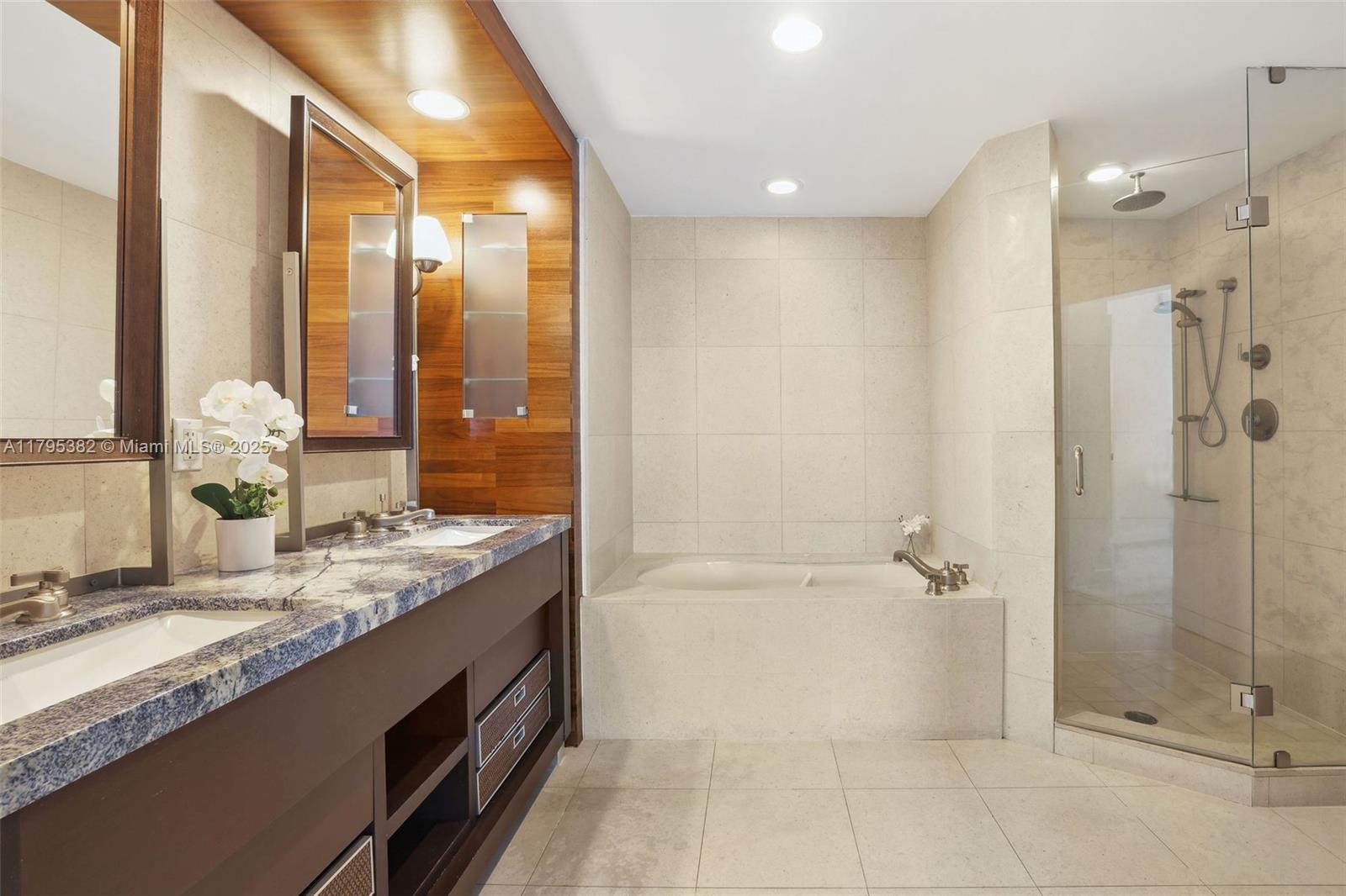 6799 Collins Avenue, Unit 1106 Miami Beach, FL 33141 - Photo 18 of 43 a bathroom with a granite countertop sink a toilet and shower