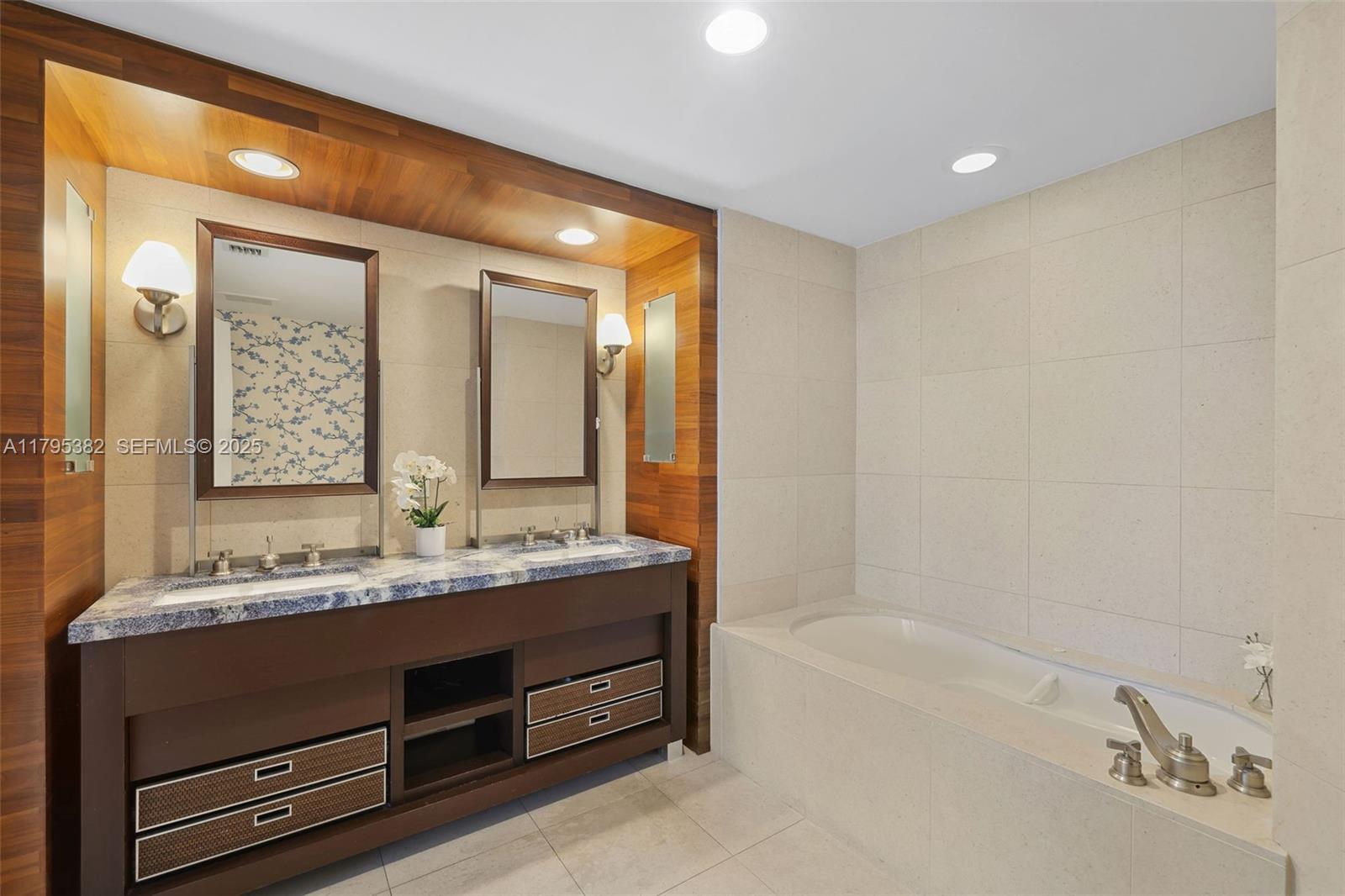 6799 Collins Avenue, Unit 1106 Miami Beach, FL 33141 - Photo 19 of 43 a bathroom with a double vanity sink and a bathtub