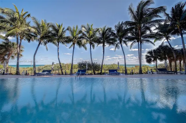 a view of a swimming pool with a table and chairs