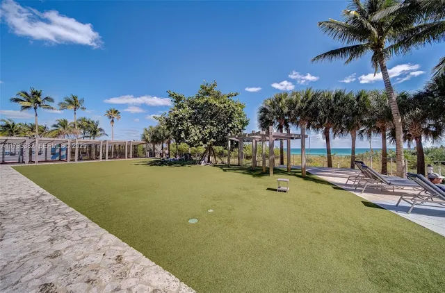 a front view of a house with a garden and yard