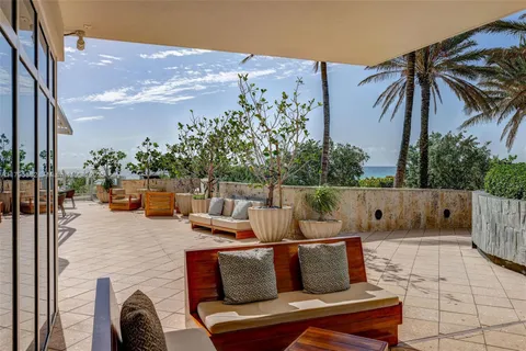 a building outdoor space with patio furniture and potted plants