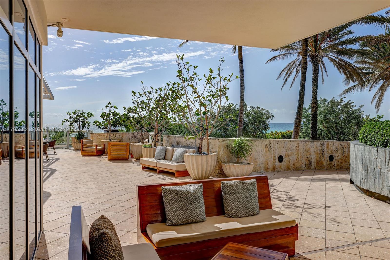 6799 Collins Avenue, Unit 1106 Miami Beach, FL 33141 - Photo 34 of 43 a outdoor living space with furniture and city view