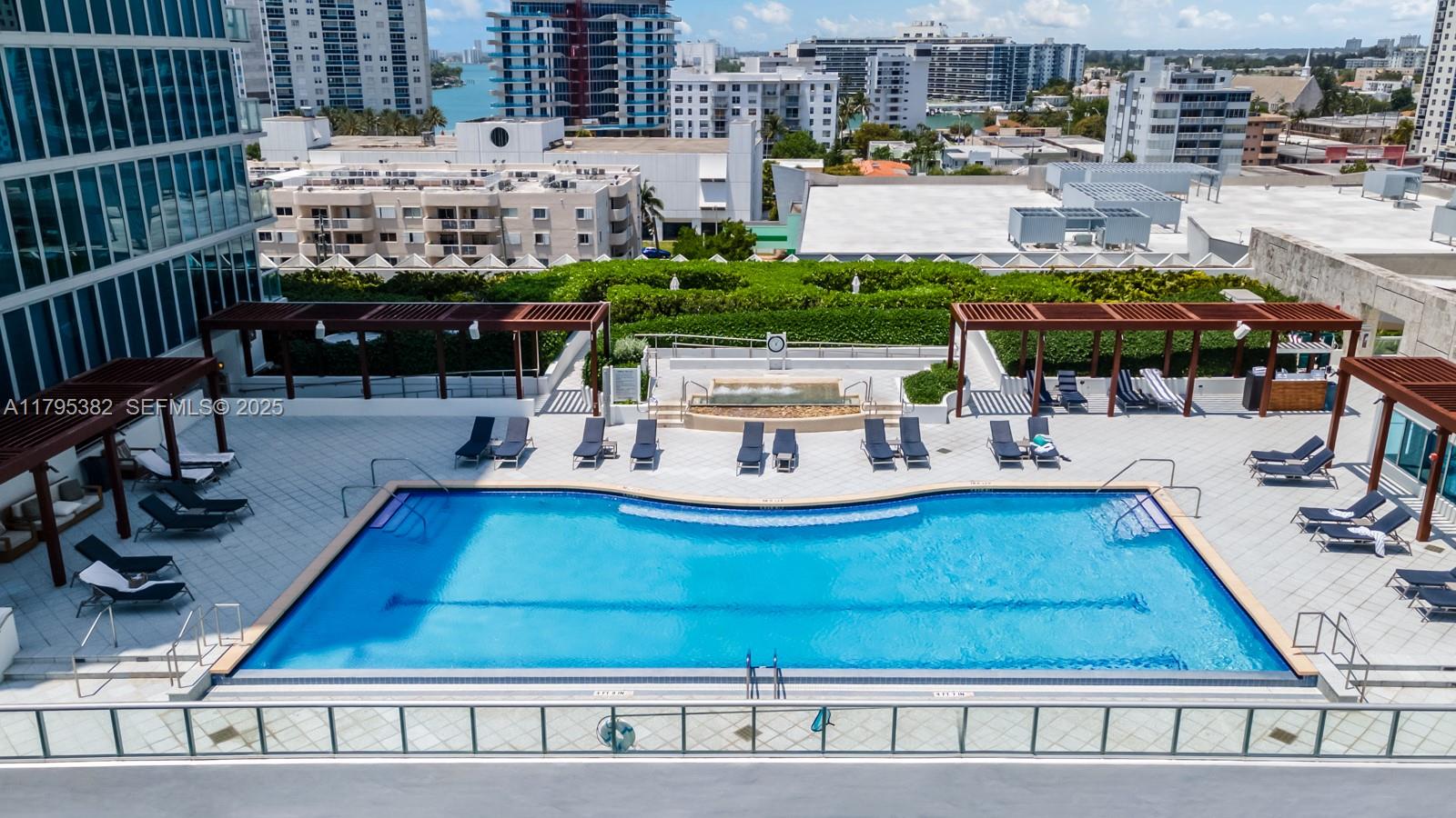 6799 Collins Avenue, Unit 1106 Miami Beach, FL 33141 - Photo 39 of 43 a view of swimming pool with outdoor seating