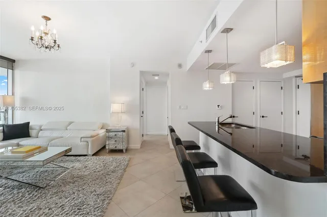 a living room with furniture and a lamp