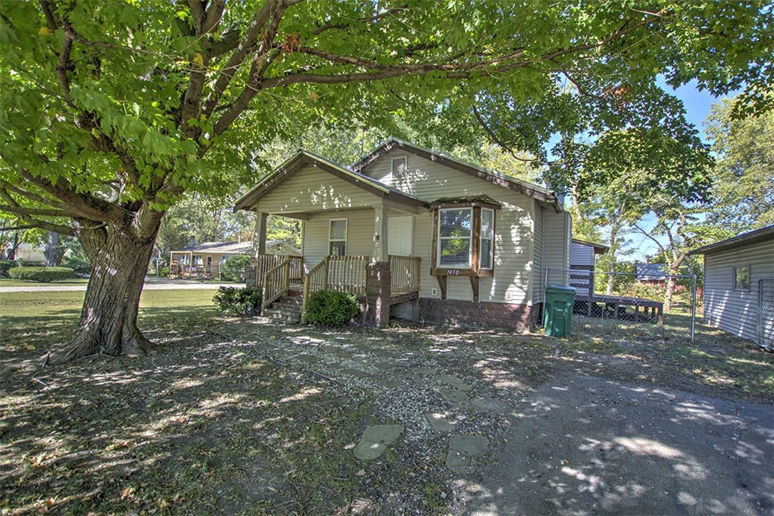 7450 West William Street Decatur, IL 62522 - Photo 2 of 18 a barn house with a big yard and large trees