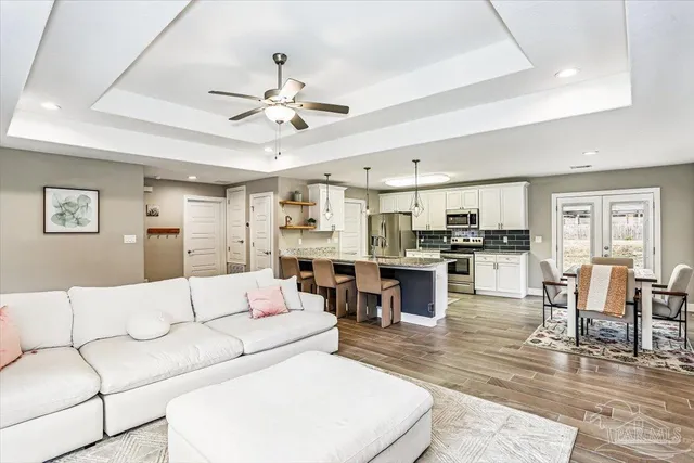 a living room with furniture and kitchen view