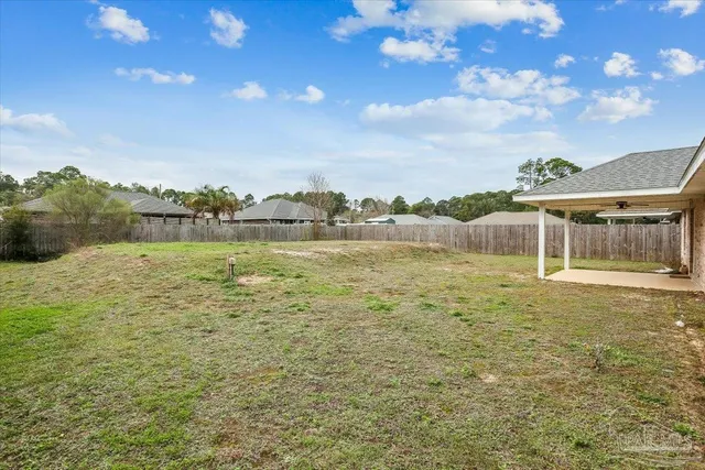 a view of a lake with houses in the back