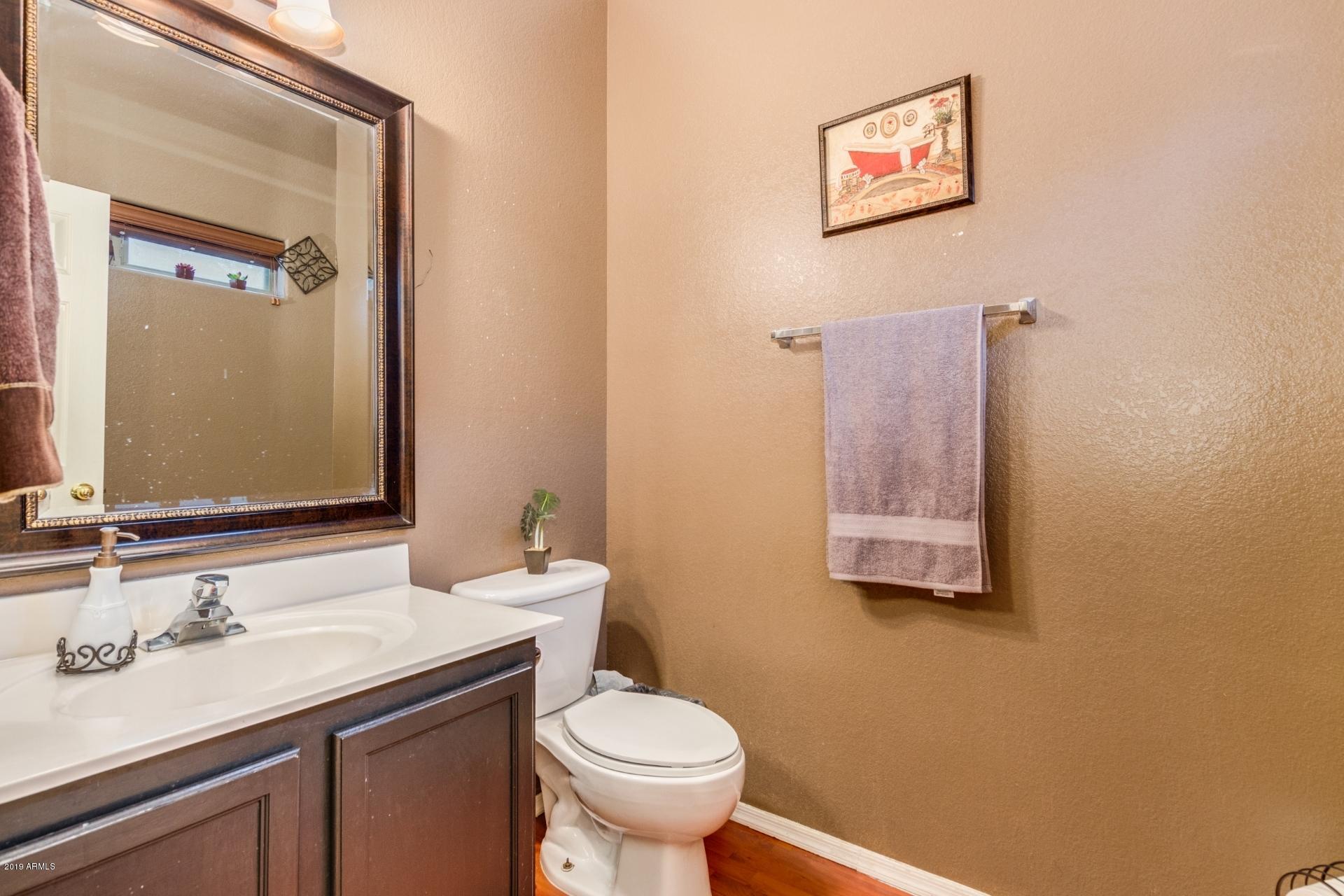 10434 East Bonnell Street Apache Junction, AZ 85120 - Photo 12 of 21 a bathroom with a granite countertop sink mirror and toilet